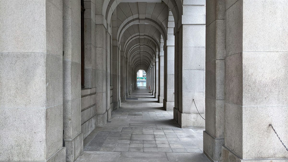A granite arcade of repeating stone arches
